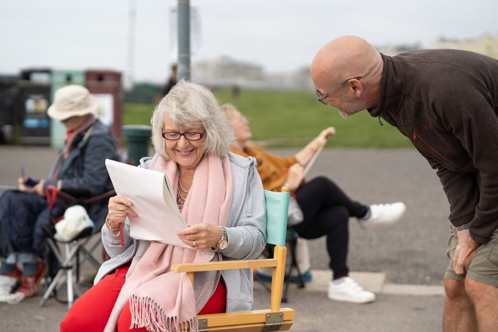 Smiling older woman talking with art instructor