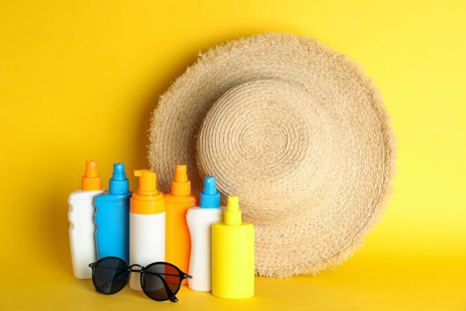Summer vacation accessories on color background, space for text. Safe tan