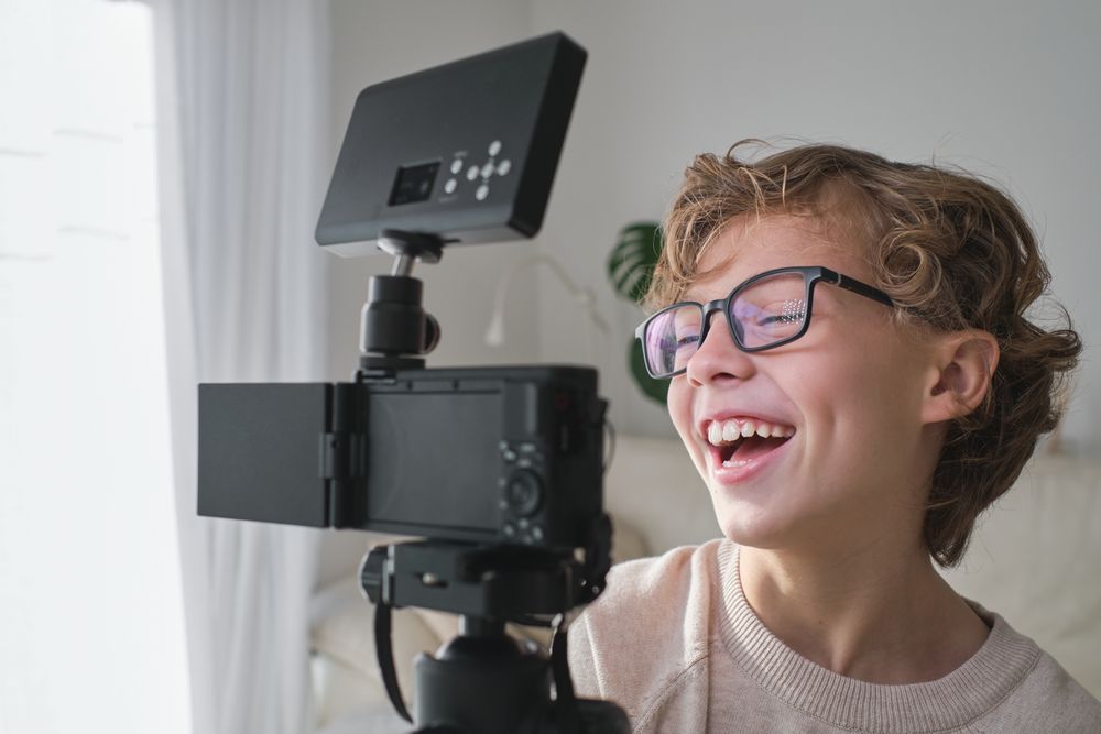 Teen smiling at camera while shooting vlog