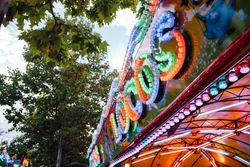 Glowing sign of amusement ride on fairground