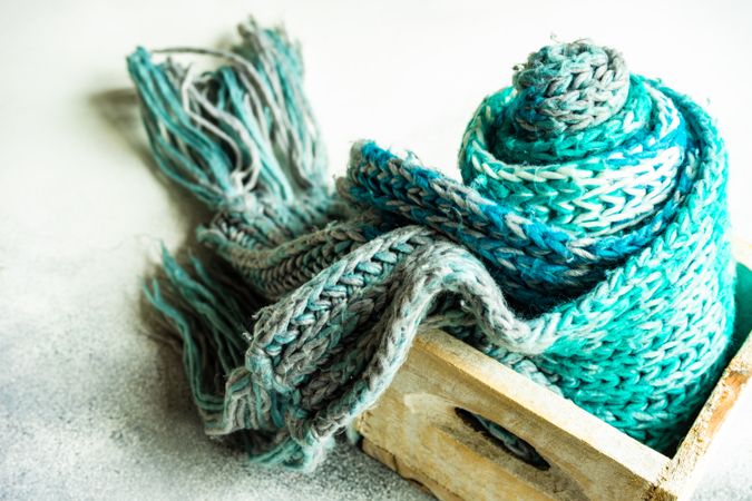 Knitted blue scarf in box on counter