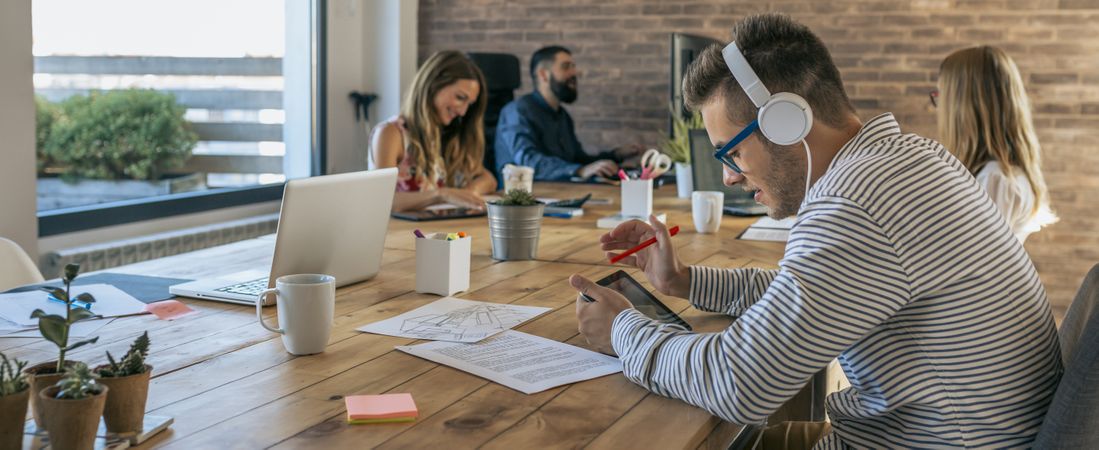 Man working with tablet and headphones in an office