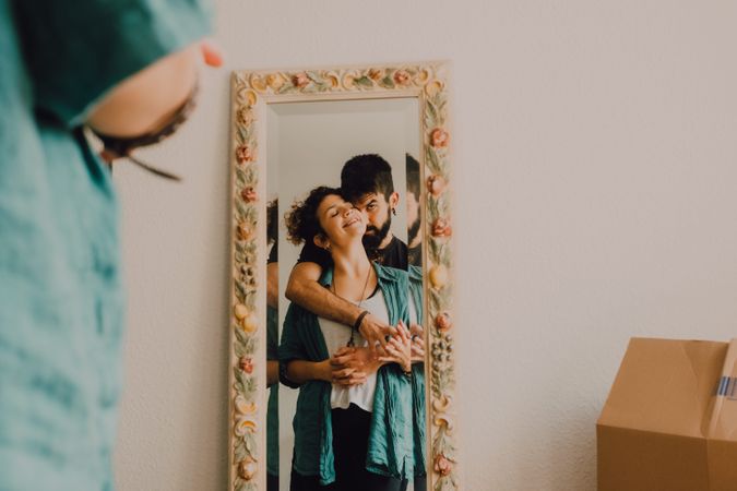 Romantic couple reflecting in rustic mirror