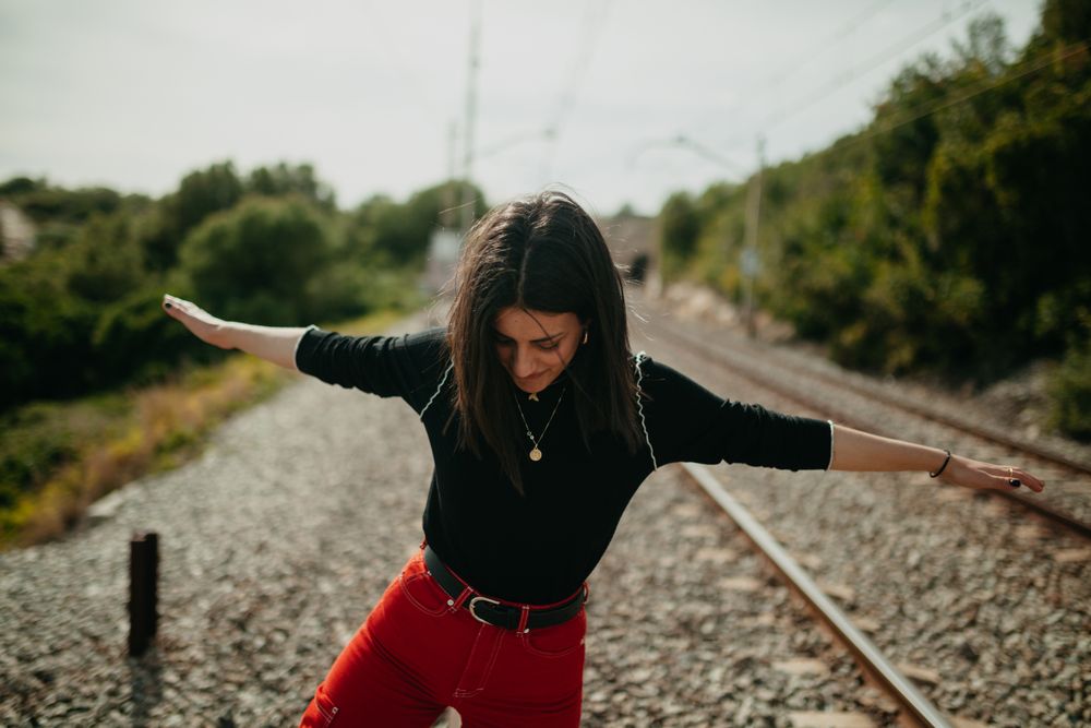 Excited woman having fun on railway