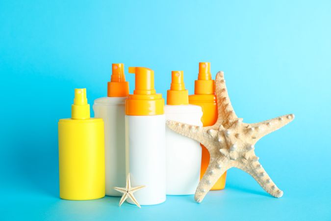 Summer vacation accessories on color background, space for text. Safe tan