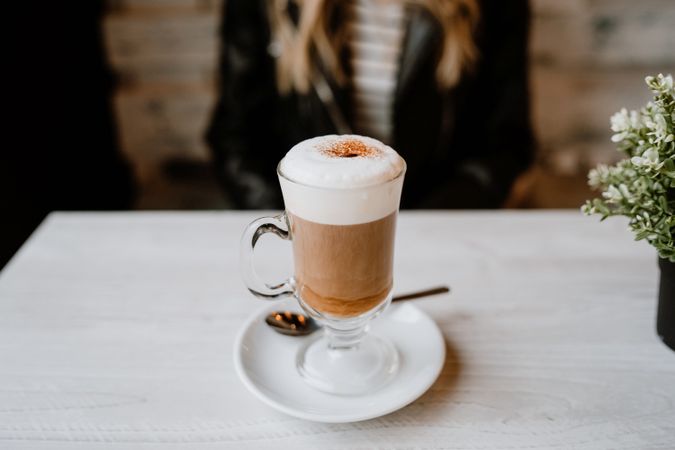 Woman drinking coffee from a glass