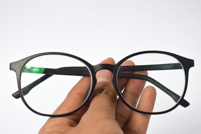 Spectacles being held by hand