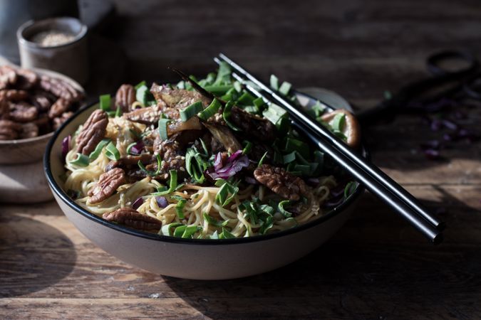 Miso noodles with egg plants and shiitake in bowl on table