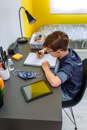 Teenager doing homework in his room