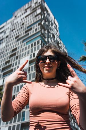 Portrait of 16 year old girl making funny gestures.