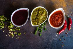 Top view of three spicy traditional Georgian sauces