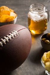 Snacks, beer and american football ball
