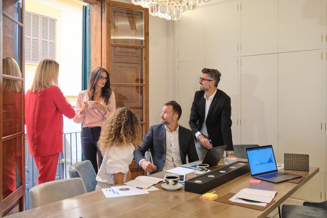 Group of colleagues discussing business in office