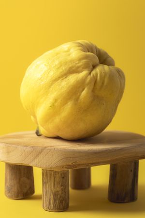 Quince fruit on a tiny wooden table