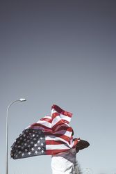 Casual man with American flag on street