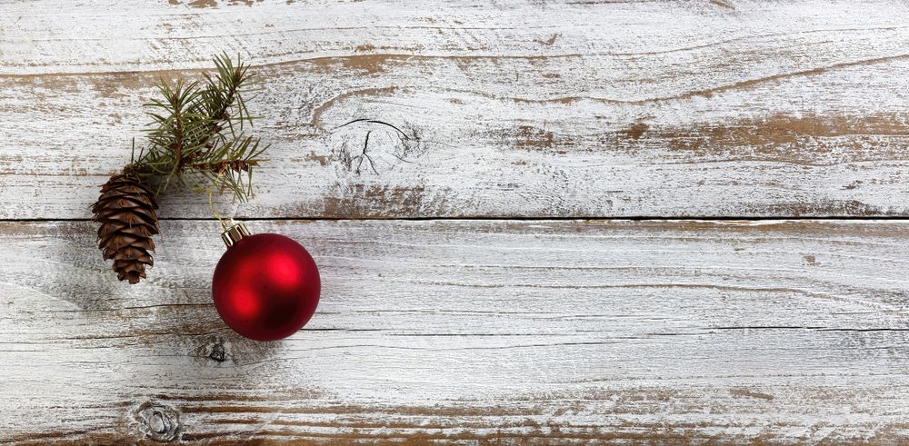 Traditional red ball and pine cone decoration on a wood background for the Christmas or New Year holiday season