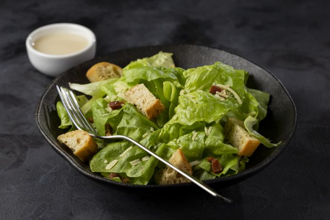Caesar salad with croutons and bacon.