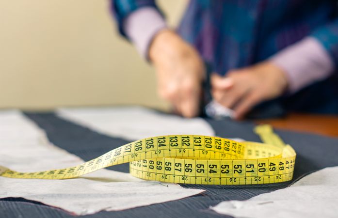 Measuring tape with dressmaker cutting in background