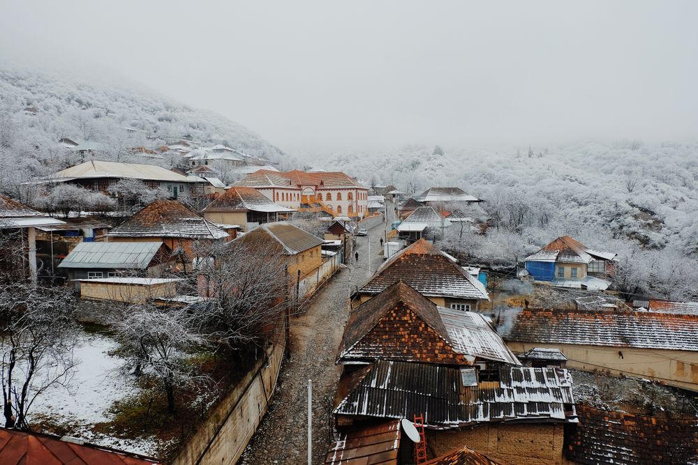 Houses near snow covered mountain