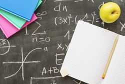 Chalkboard with books, apple and notebook