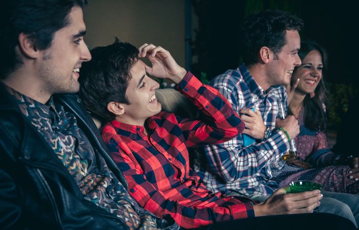 Happy friends laughing together at a party