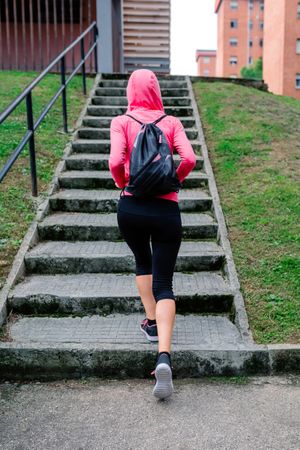 Female athlete going up stairs outdoors
