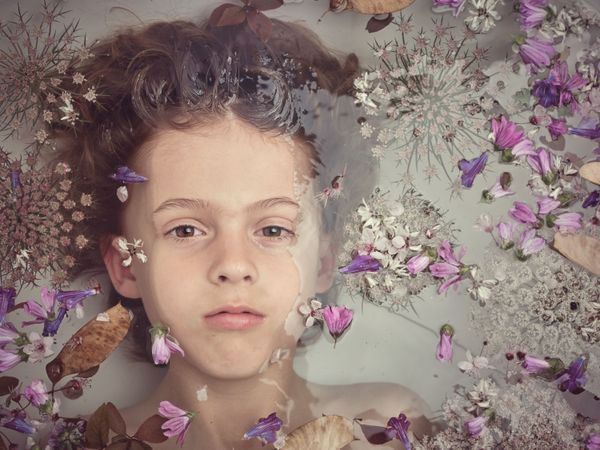 Boy in bath with flowers