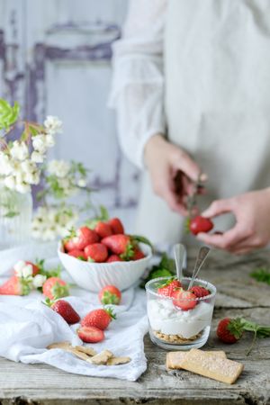 Confectioner cooking dessert of ripe strawberries