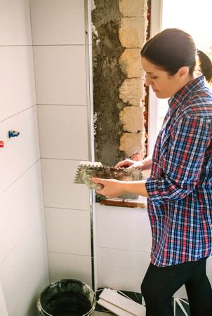 Mason working on a bathroom renovation