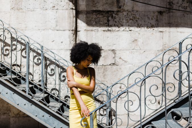Stylish female leaning on railing outdoors