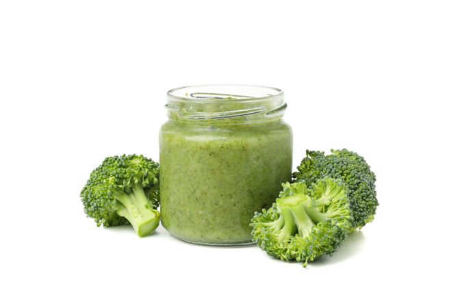 Glass jar with healthy baby food isolated on plain background