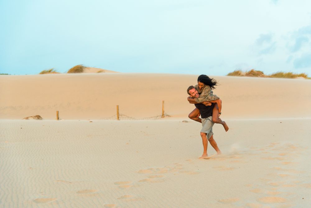Piggyback, having fun at beach