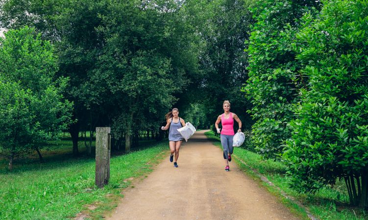 Two women doing plogging
