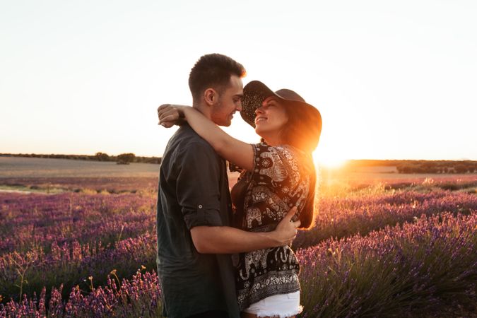 Couple in love in a lavender field at sunset