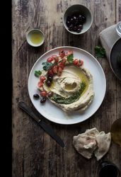 Pesto hummus with tomatoes and beans