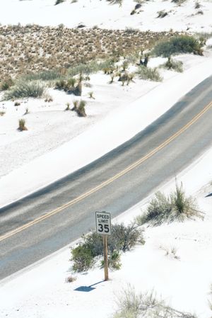 Asphalt road at scenic mountain valley and power line