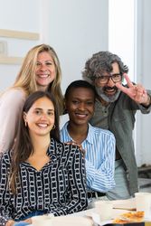 Cheerful diverse coworking women looking at camera