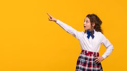 Girl pointing to side, surprised expression