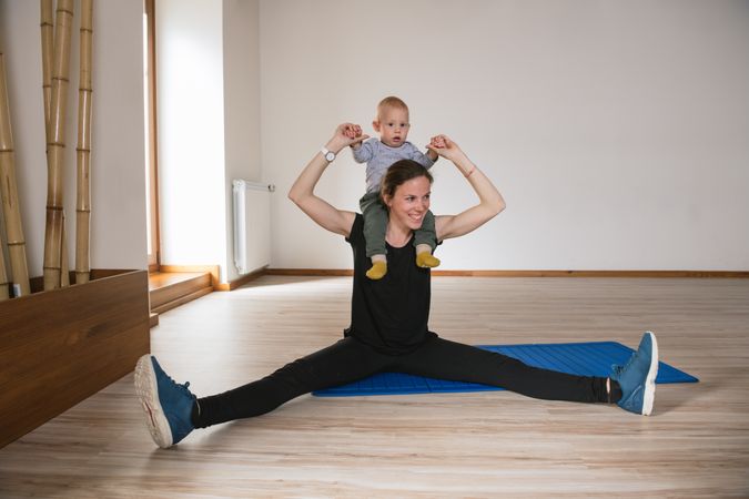 Mother exercising with baby in gym