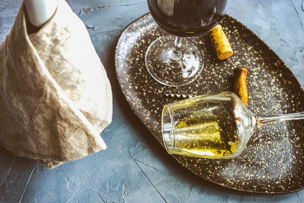 Bottle of wine and glass on concrete background with copy space