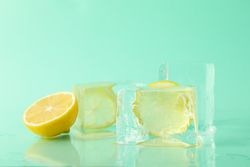 Large square ice cubes with lemon, in mint room