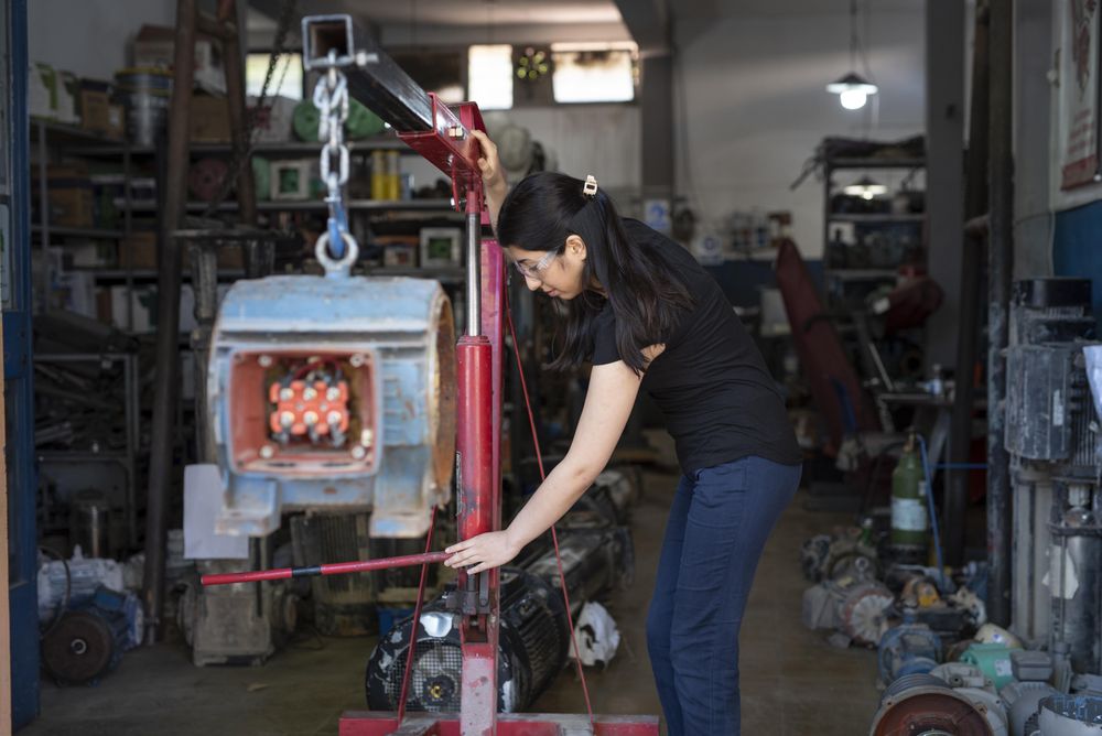Woman in factory working with machines