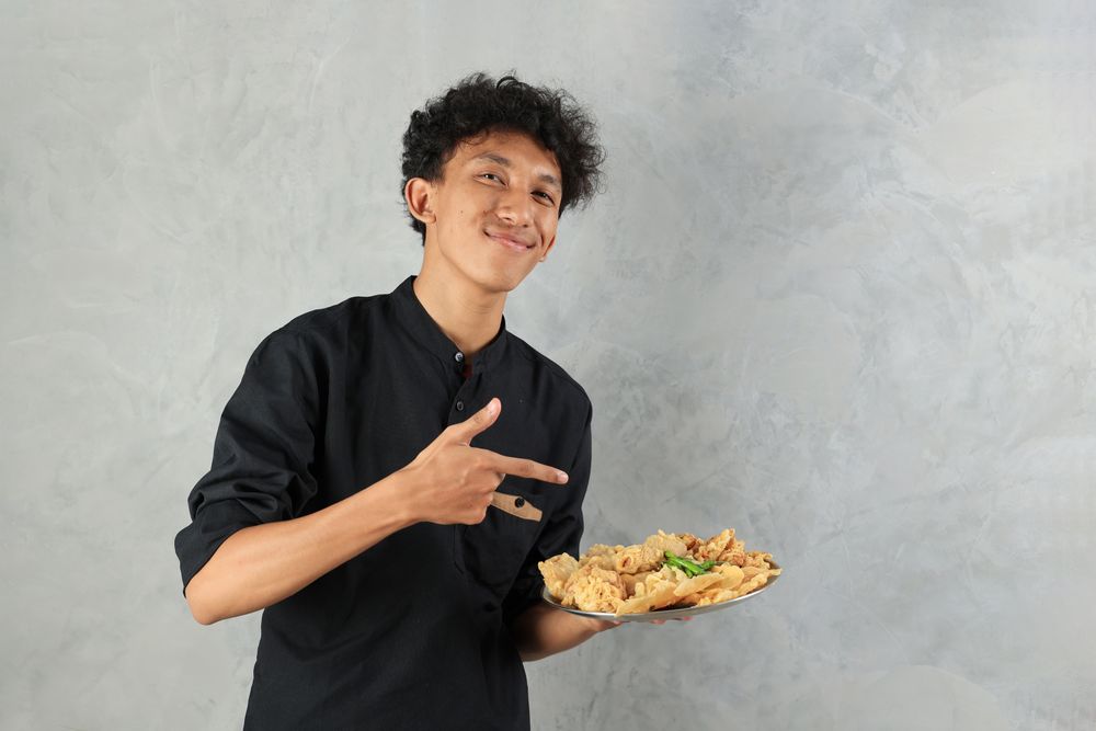 Asian Male Holding Various Gorengan with Green Chilli for Breaking Fast