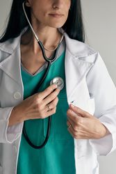 Crop doctor listening to heartbeat with stethoscope at work