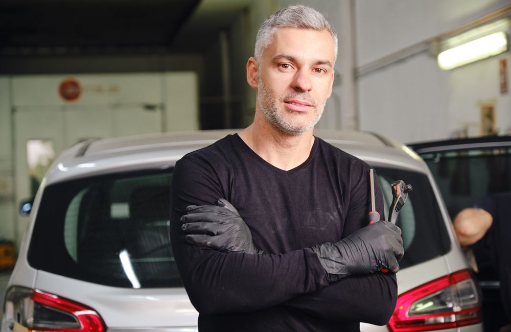 Confident mechanic in garage