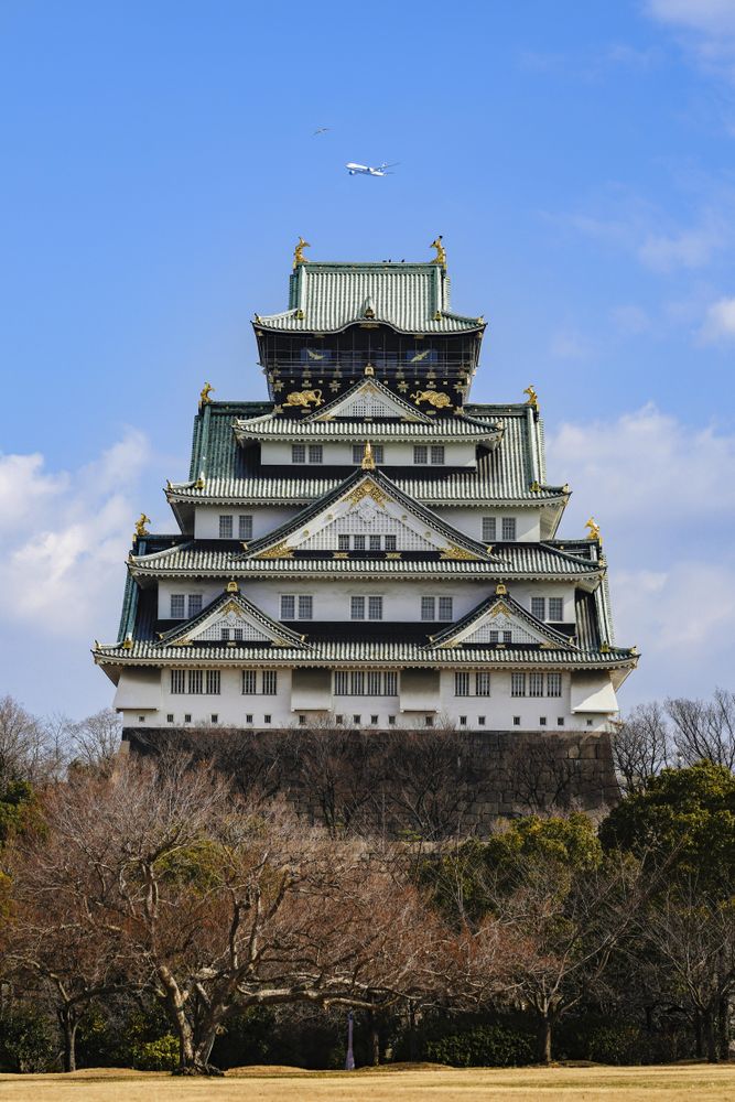 Temple in Japan with airplane flying above