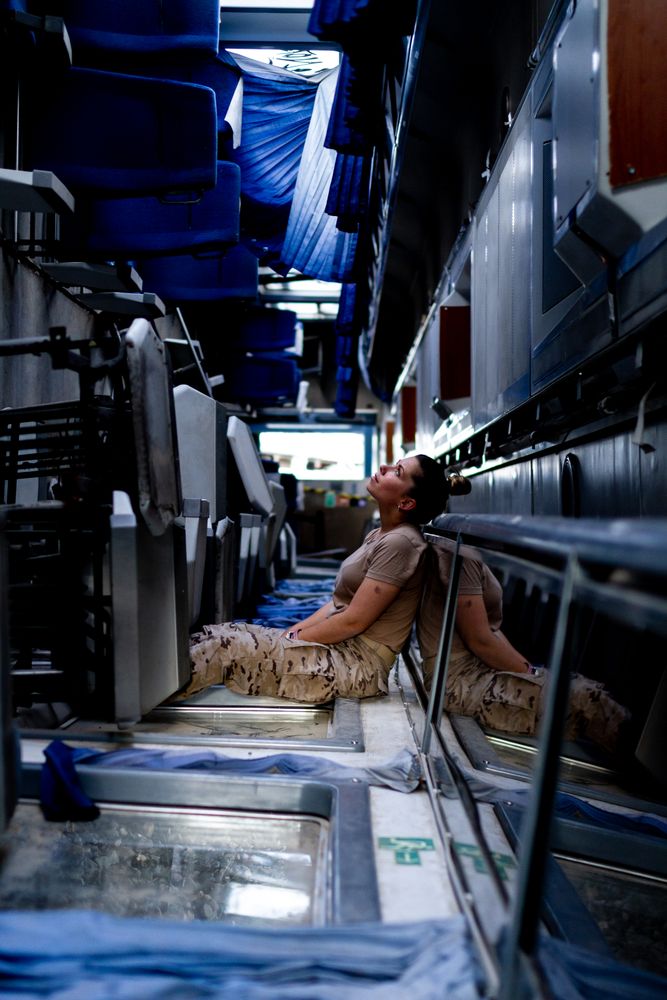 Military woman looking up inside vehicle