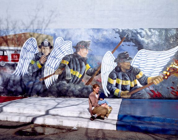 Mother and child in front of a Chicago Firefighter Mural