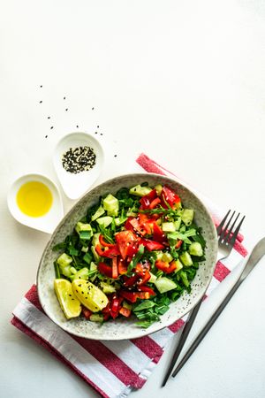Top view of big grey bowl of fresh salad