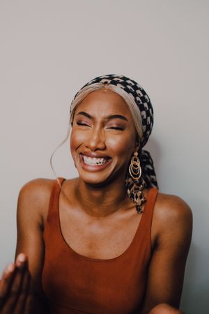 Black woman wearing headscarf and brown dress